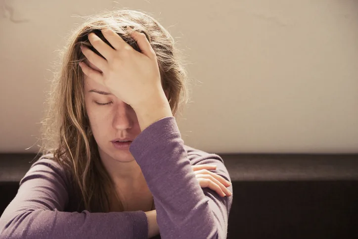 Person experiencing chronic fatigue, brain fog, and exhaustion